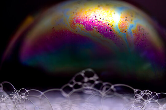 The colorful world of soap bubbles resembling space and honeycomb