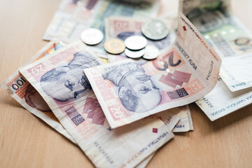 Croatian money (HRK)  in paper and coins on wooden table