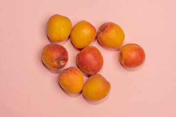 Fototapeta na wymiar Pile of small, fresh, ripe, juicy, peaches on a colourful background, stock picture.