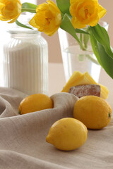Yellow lemons, sugar and yellow tulips on the table. Conceptual Spring photo. Kitchen Photos. Interior.Vitamins 