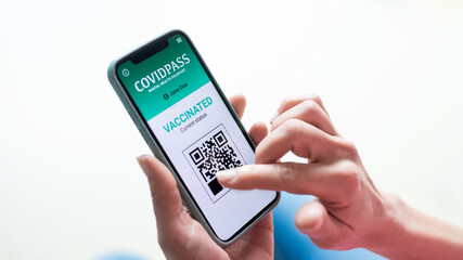 Close-up of female hands holding smartphone, coronavirus and vaccination concept.