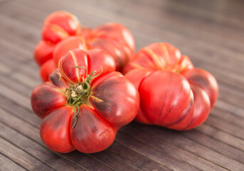 ripe appetizing merinda tomatoes on a wooden table