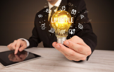 Businessman holding a light bulb, social media concept