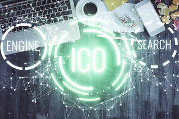 Blockchain theme hologram drawings over computer on the desktop background. Top view. Double...