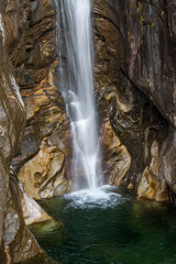 Fototapeta na wymiar small waterfall near Maggia, Ticino