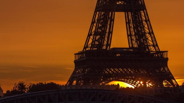 Eiffel Tower sunrise timelapse with boats on Seine river and in Paris, France.