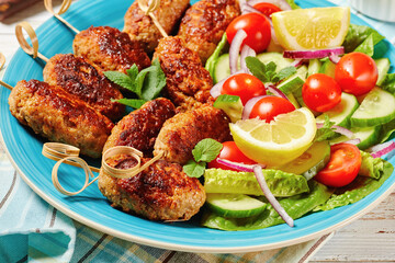 Lamb kofta kebabs with vegetables, top view
