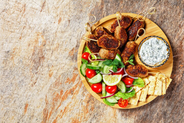 Greek lamb kofta skewers, top view, copy space