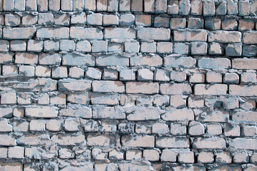 cobblestone piled in a heap. brick gray wall. dark unusual texture. blue geometric background