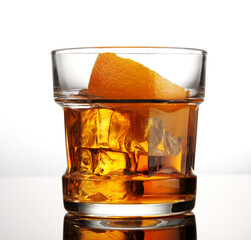 Glass of whiskey with ice and orange peel