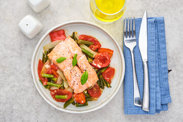 Delicious fried salmon with vegetables, top view.