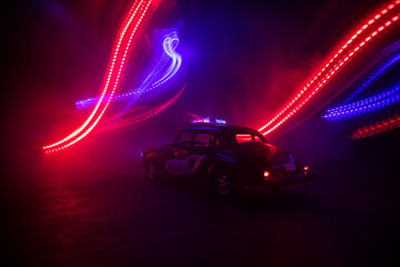 Police car chasing a car at night with fog background. 911 Emergency response police car speeding...