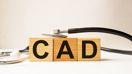 word CAD on wooden blocks. medical concept . the medicine