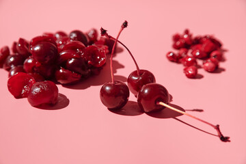 peeled ripe pitted cherries. pink background
