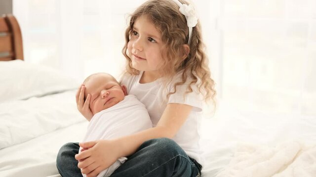 Little girl with newborn baby