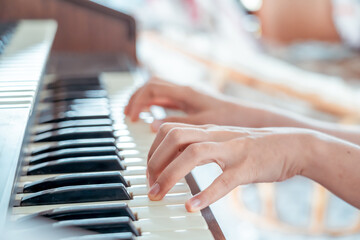 Fototapeta premium Female pianist hands on grand piano keyboard.