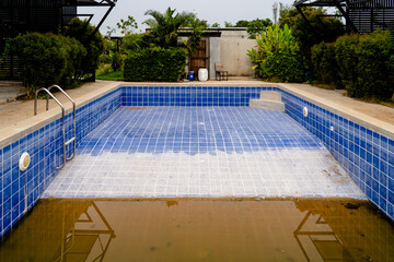 Dilapidated old building with ruined swimming pool.