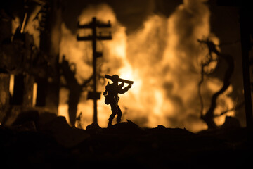 Military soldier silhouette with bazooka. War Concept. Military silhouettes fighting scene on war fog sky background, Soldier Silhouette aiming to the target at night.