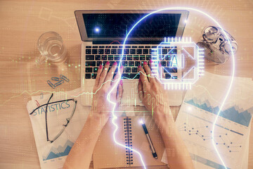 Double exposure of woman working on computer andhuman brain hologram drawing. Top View. Ai concept.