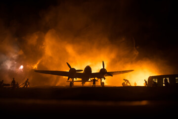 German Junker (Ju-88) night bomber at night. Artwork decoration with scale model of jet-propelled plane in possession. Toned foggy background with light. War scene.