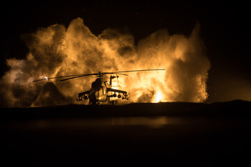 Silhouette of military helicopter ready to fly from conflict zone. Decorated night footage with...