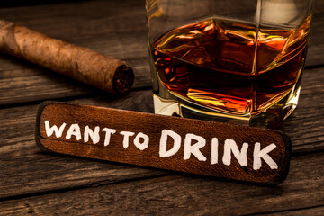 Glass of brandy with cuban cigar and the wooden plank on it is an inscription 