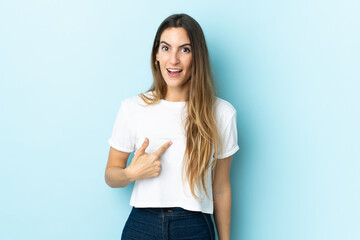 Young caucasian woman over isolated background with surprise facial expression