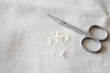 Nail scissors and a bunch of clipped human nails