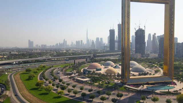 Dubai skyline seen through gigantic golden Frame at Zabeel park aerial view