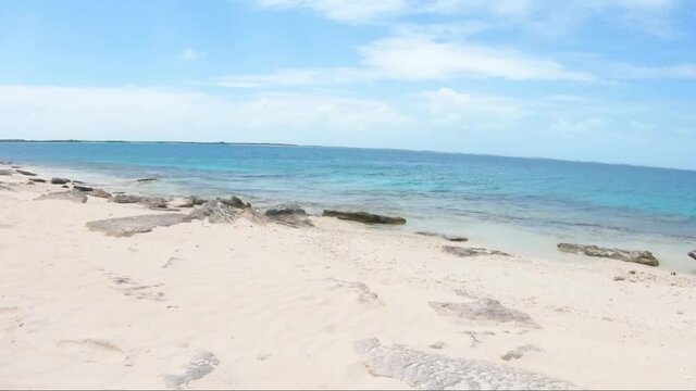 tropical beach scene  pan rigth  of The Shore beach white sand and blue sky crasky los roques venezuela