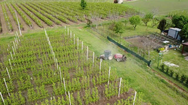Aerial view of farmer spraying pesticides