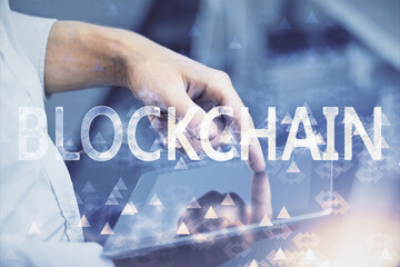 Double exposure of man's hands holding and using a phone and crypto currency blockchain theme...