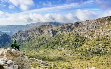 man sitting looking at the mountain