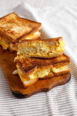 Homemade Grilled Macaroni and Cheese Sandwich on a rustic wooden board, low angle view.