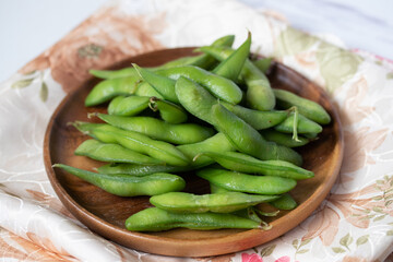 Japanese food edamame nibbles, boiled green soy beans