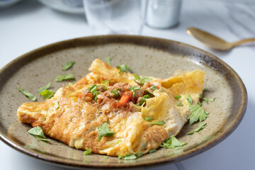 Egg stuffed with minced pork and tomato crat, fried to combine, wrapped in egg