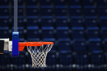 Basketball hoop on the background of the empty seats of the sports arena