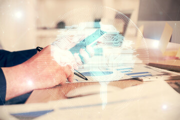 Double exposure of man's hand holding and using a digital device and brain hologram drawing. Data concept.