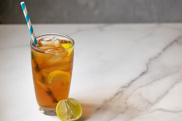 Lemon tea in clear glass on marble background Copy space