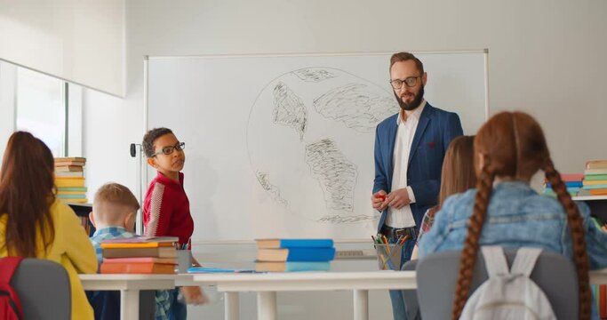Cheerful teenage students sitting in classroom and discussing ecological problems
