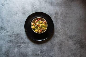 Indian snacks aloo jeera or boiled potatoes mixed with pepper and chopped onions.