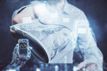 Multi exposure of envelop drawing hologram and USA dollars bills and man hands. Technology concept.