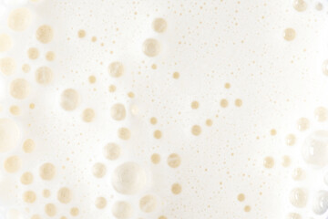 Foam of milkshake, cocktail with bubbles as texture or background, top view