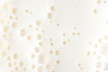 Foam of milkshake, cocktail with bubbles as texture or background, top view
