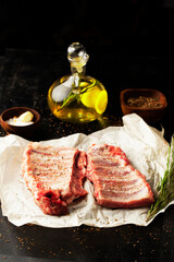 Raw pork ribs with spices, salt and rosemary on dark wooden background. - 431522679