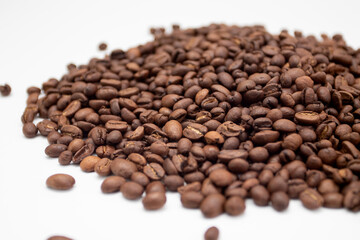 A bunch of coffee beans. Coffee beans isolated on white background. Fresh roasted coffee beans.