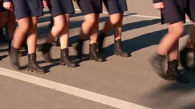 parade of military women and men legs in the frame marching