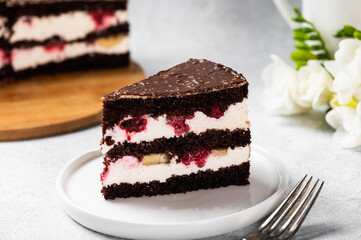 Raspberry cake with chocolate. Chocolate cake with berries. Piece of cake on a plate. Dessert on white background. Black forest cake