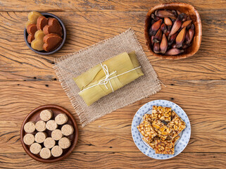Typical brazilian june festival food. Pamonha, potato sweet, pine tree seed and peanut candy