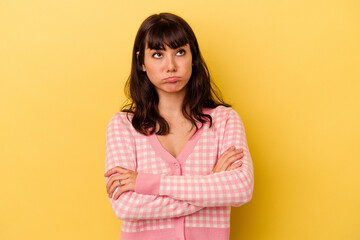 Fototapeta premium Young caucasian woman isolated on yellow background tired of a repetitive task.